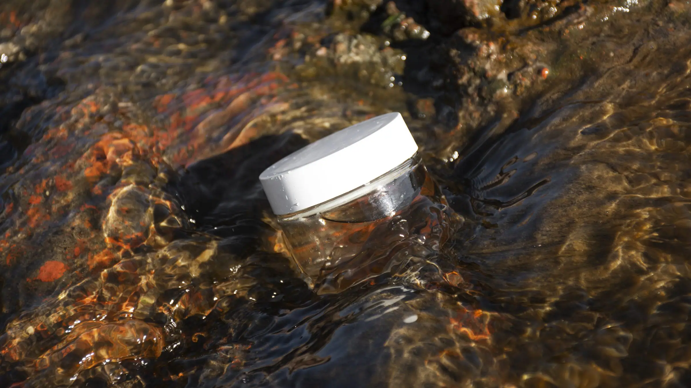 The compact water filter standing alone against a pale grey ground.