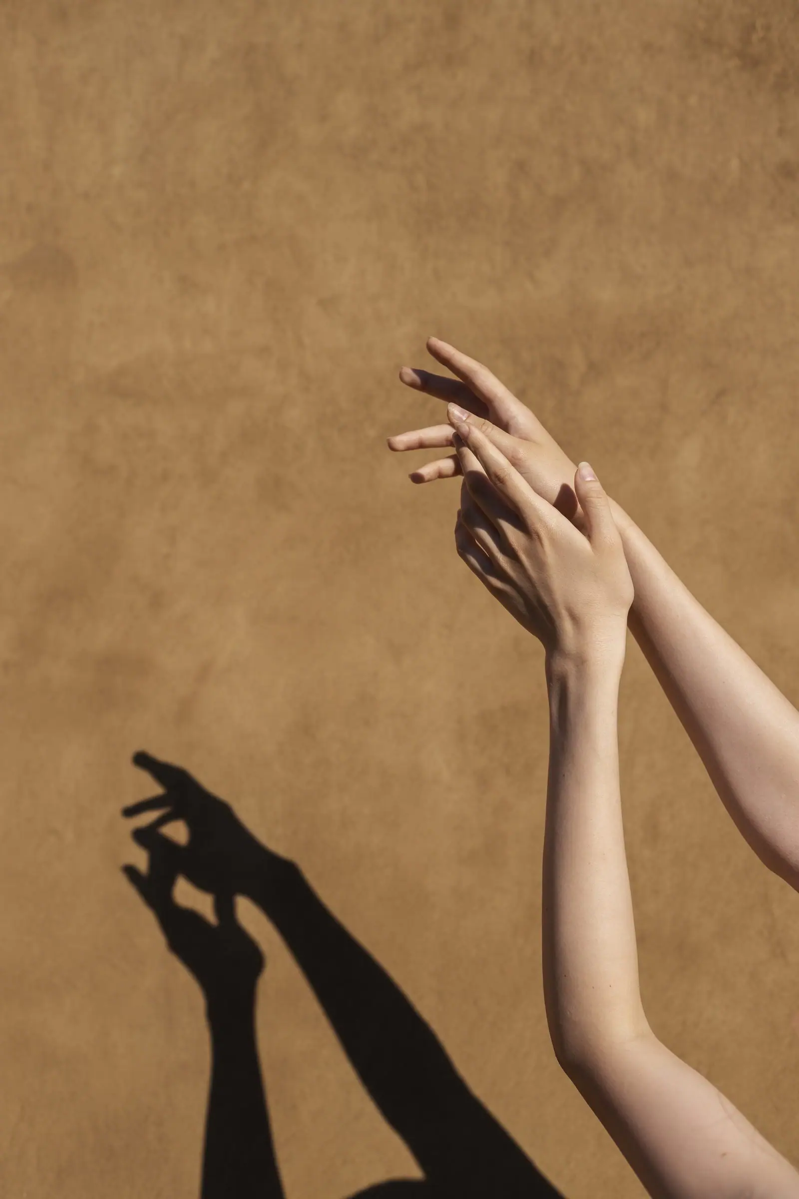 Hands drawing a comb through damp hair.